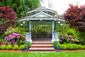 An inviting gazebo decorated with a blue ribbon, adding a stylish accent to the tranquil outdoor environment.
