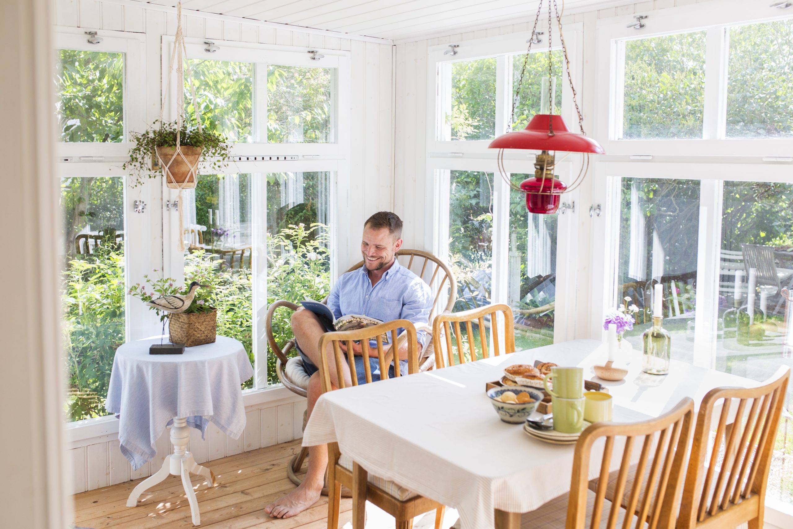 Man reading newspaper in dining room