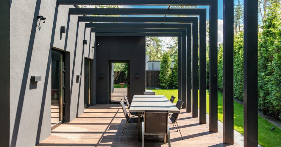 Elegant pergola with outdoor dining set in a landscaped New Orleans backyard