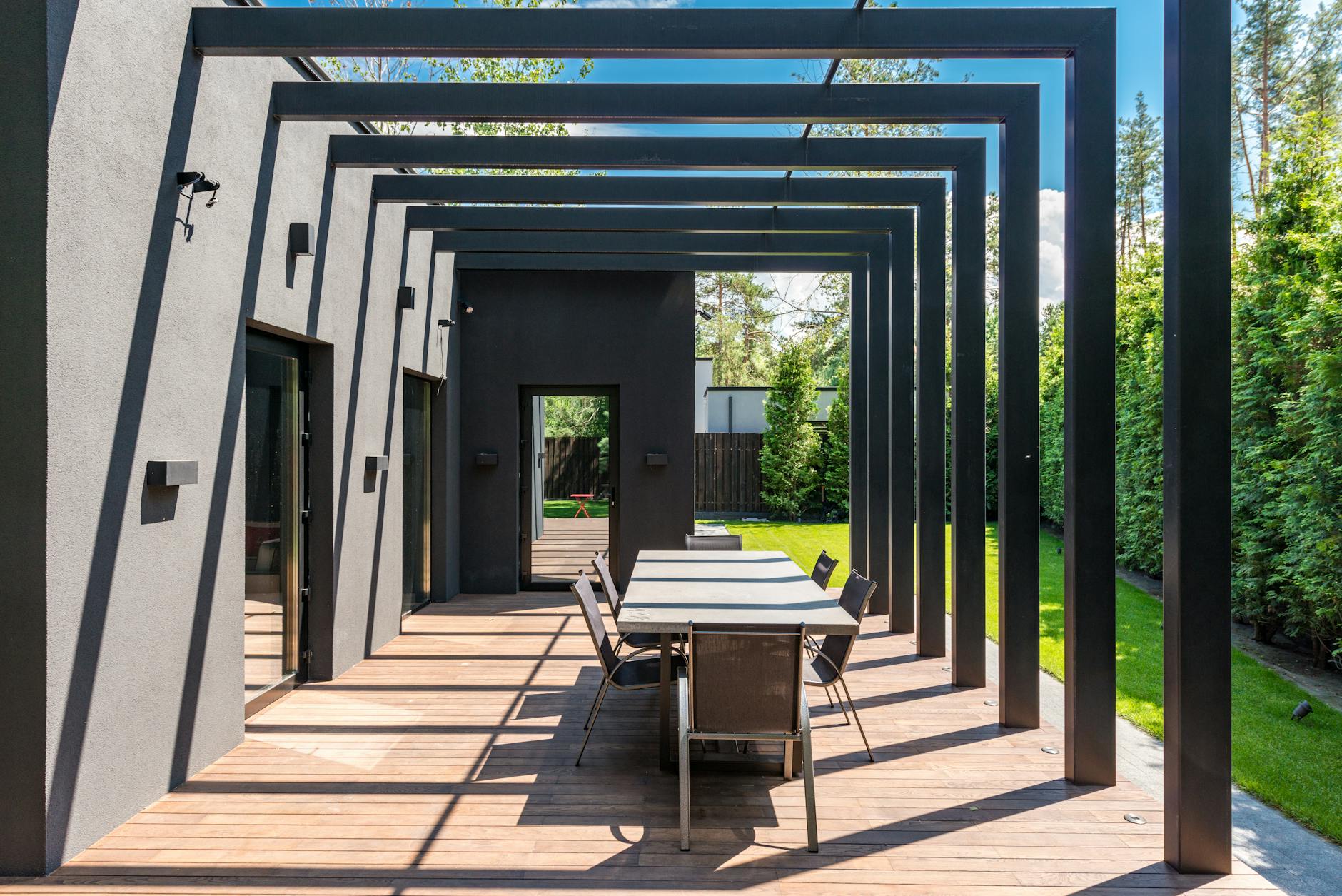Elegant pergola with outdoor dining set in a landscaped New Orleans backyard
