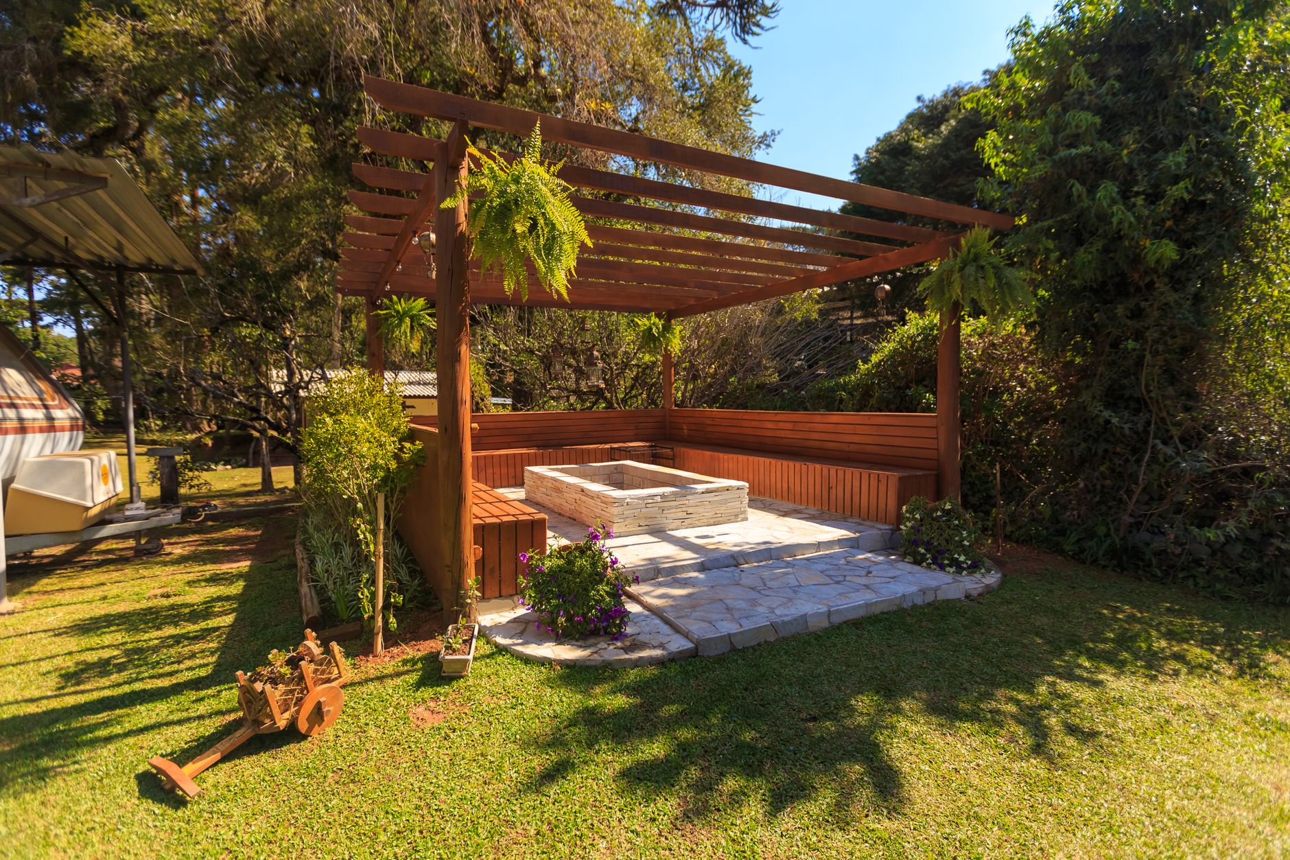 Open wood pergola built over an outdoor kitchen cooking area