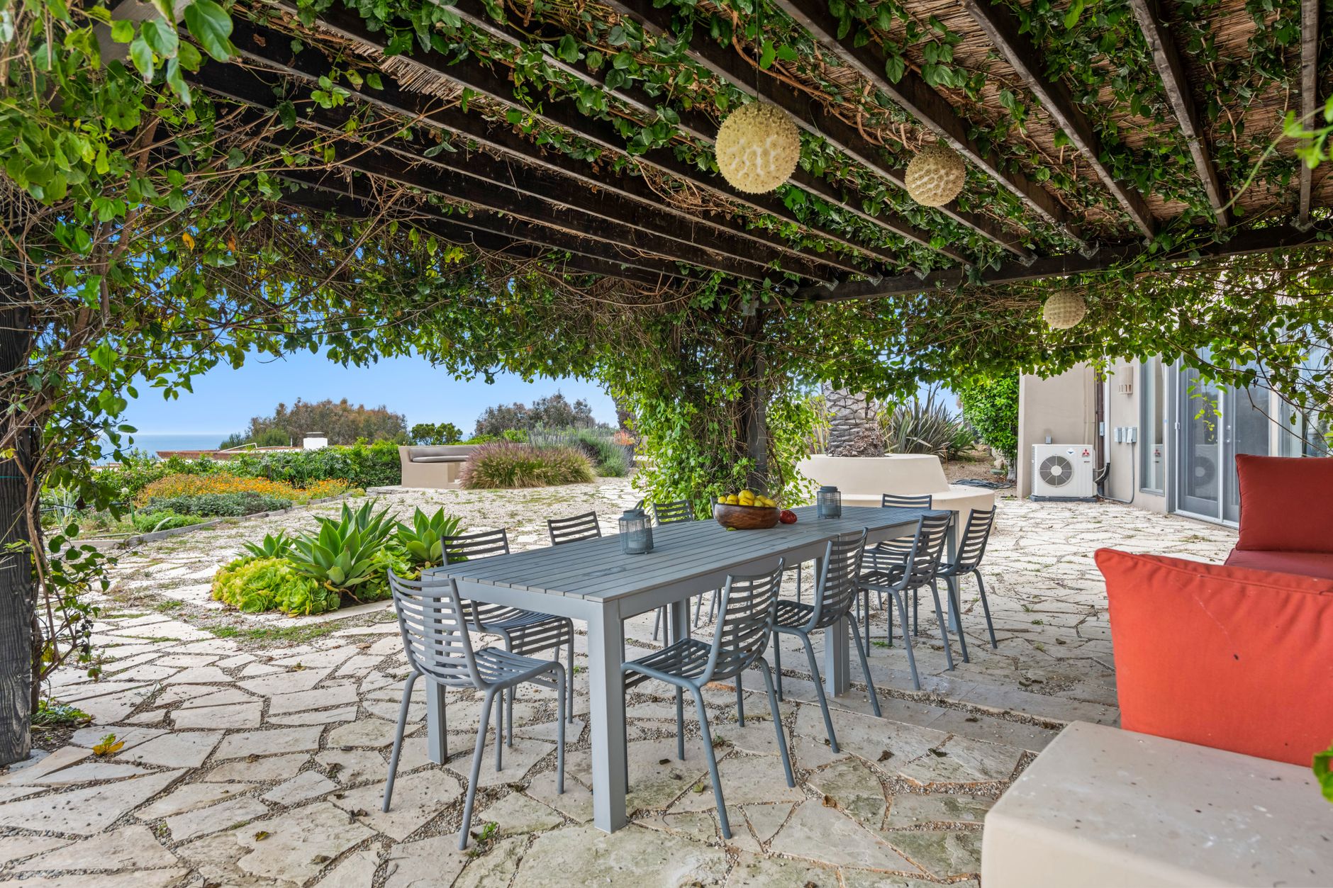 Flowering climbing vines covering a wooden pergola in a New Orleans backyard