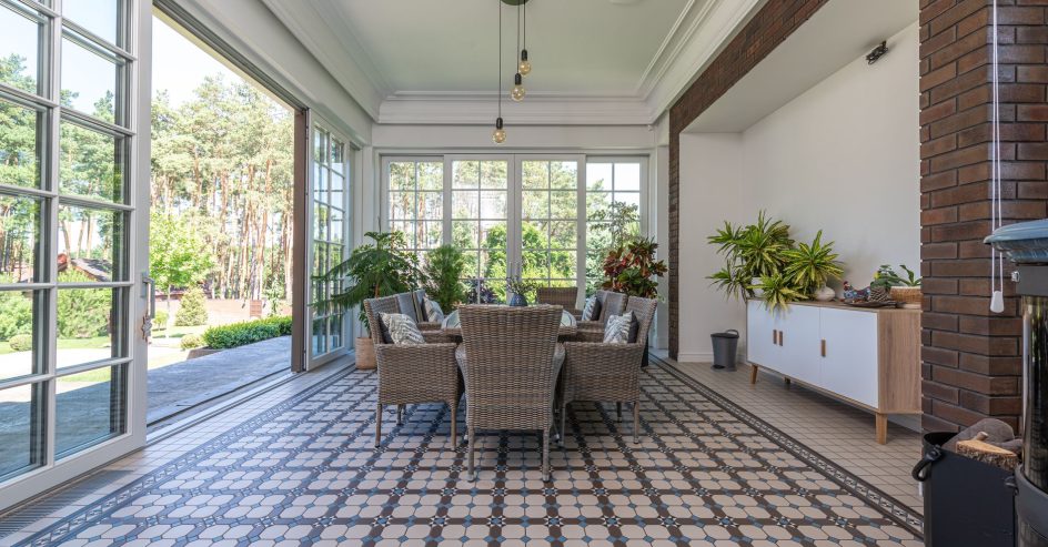 Bright sunroom with porcelain tile flooring and large windows
