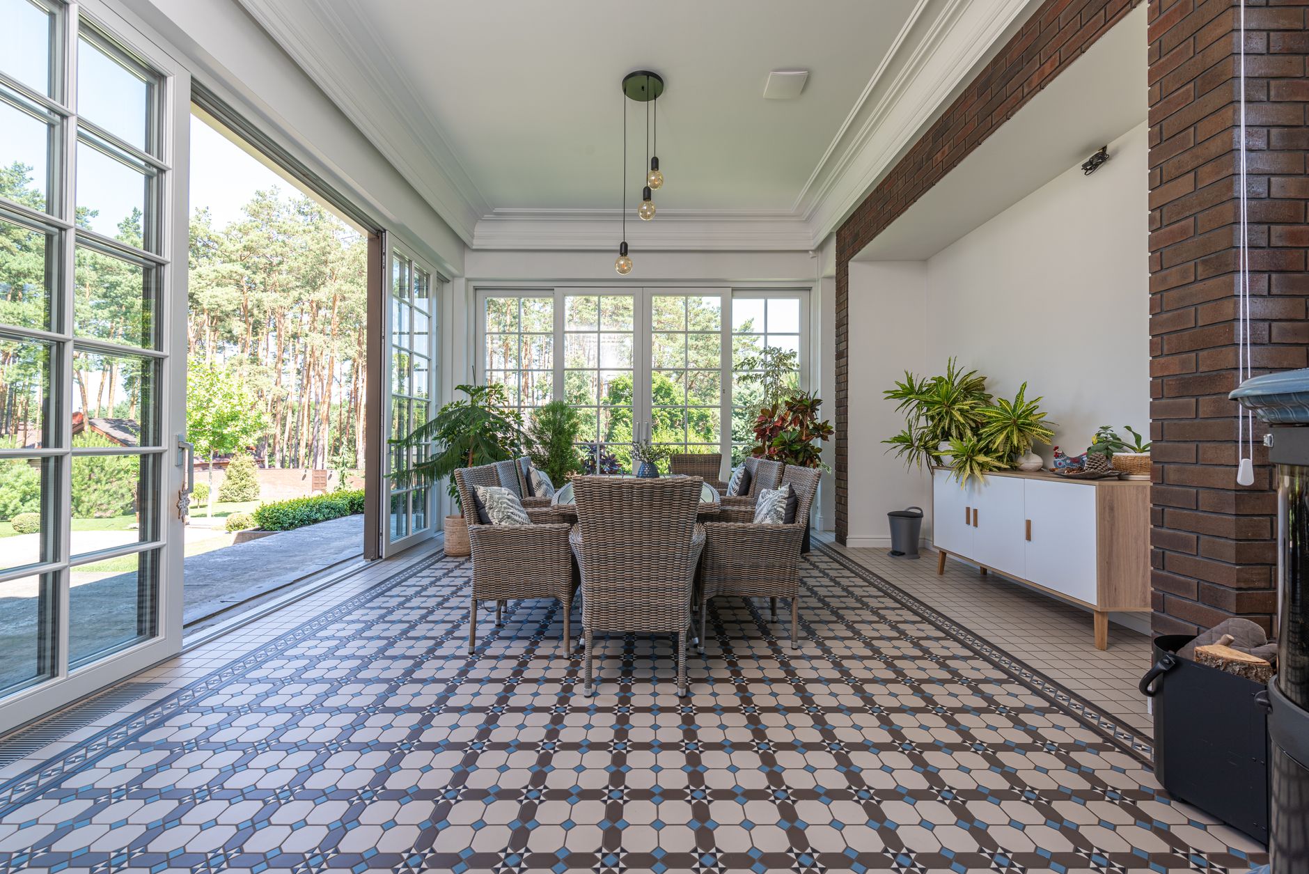 Bright sunroom with porcelain tile flooring and large windows