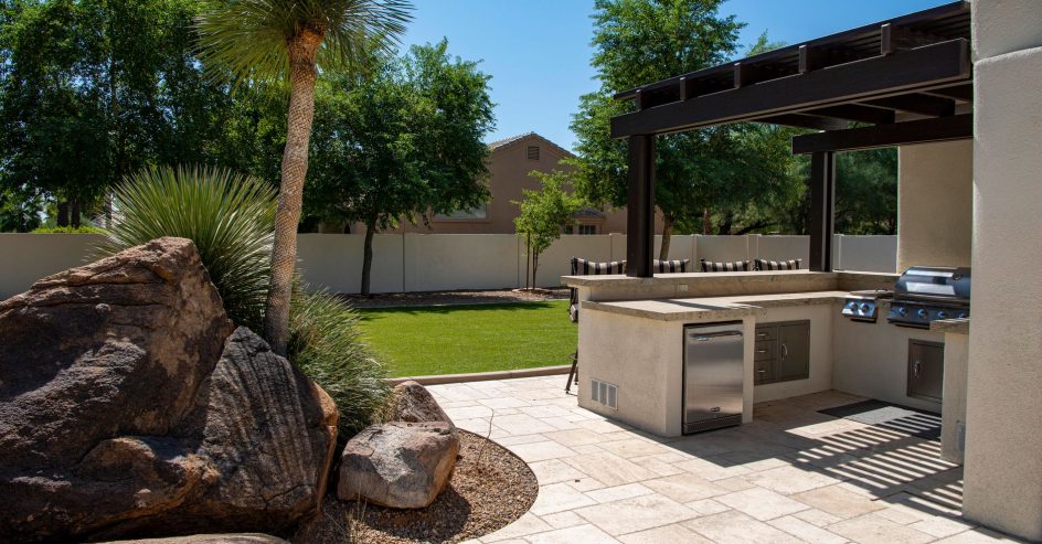 Covered outdoor kitchen with pergola roof in a New Orleans backyard