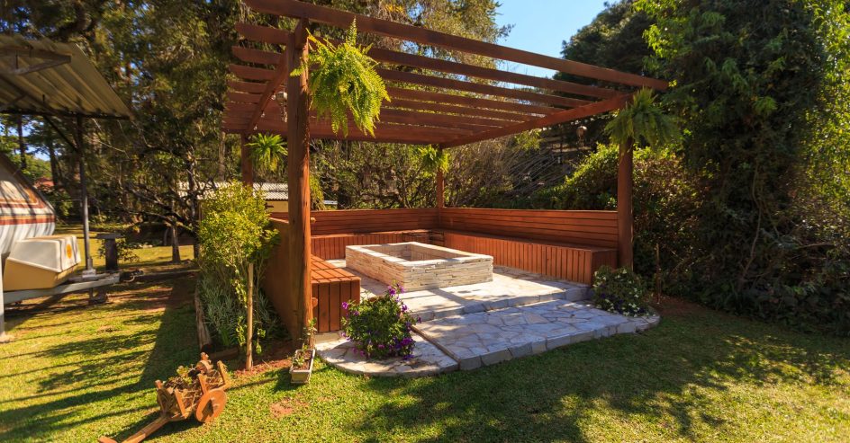 Wooden pergola shading a New Orleans backyard patio, illustrating pergola permit considerations for homeowners