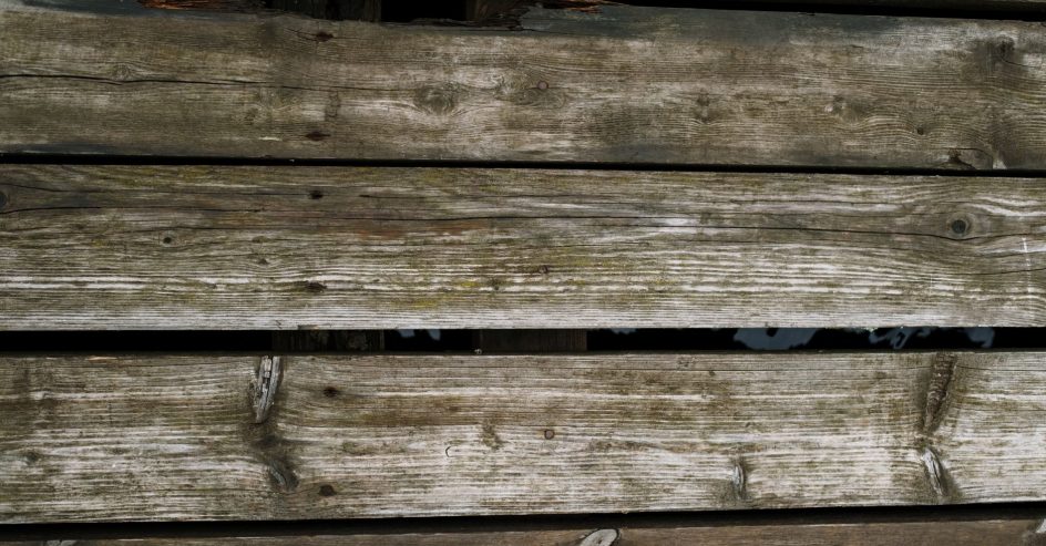 Rotted and soft wood deck boards showing signs a deck needs repair