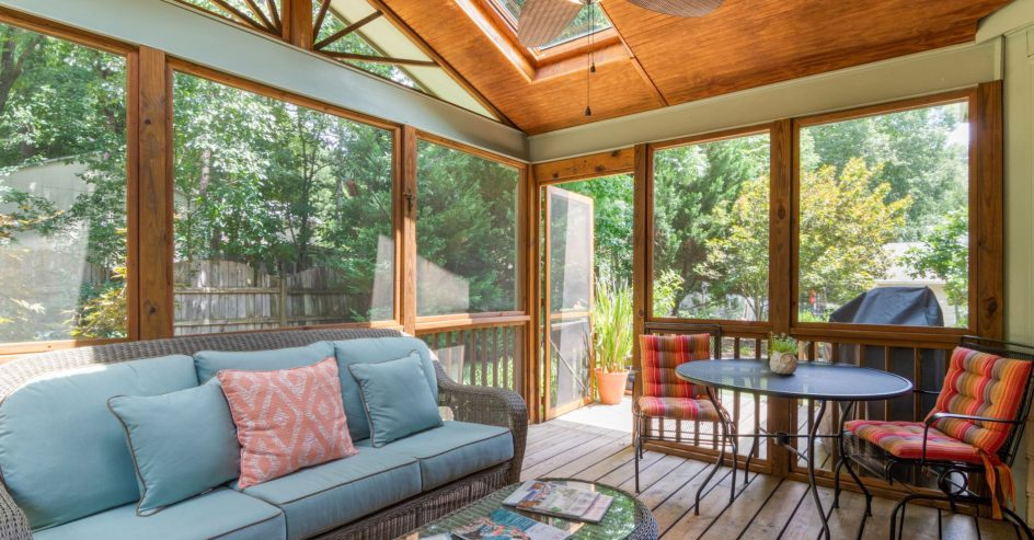 Side by side comparison of a glass sunroom and a screened porch addition on a New Orleans home