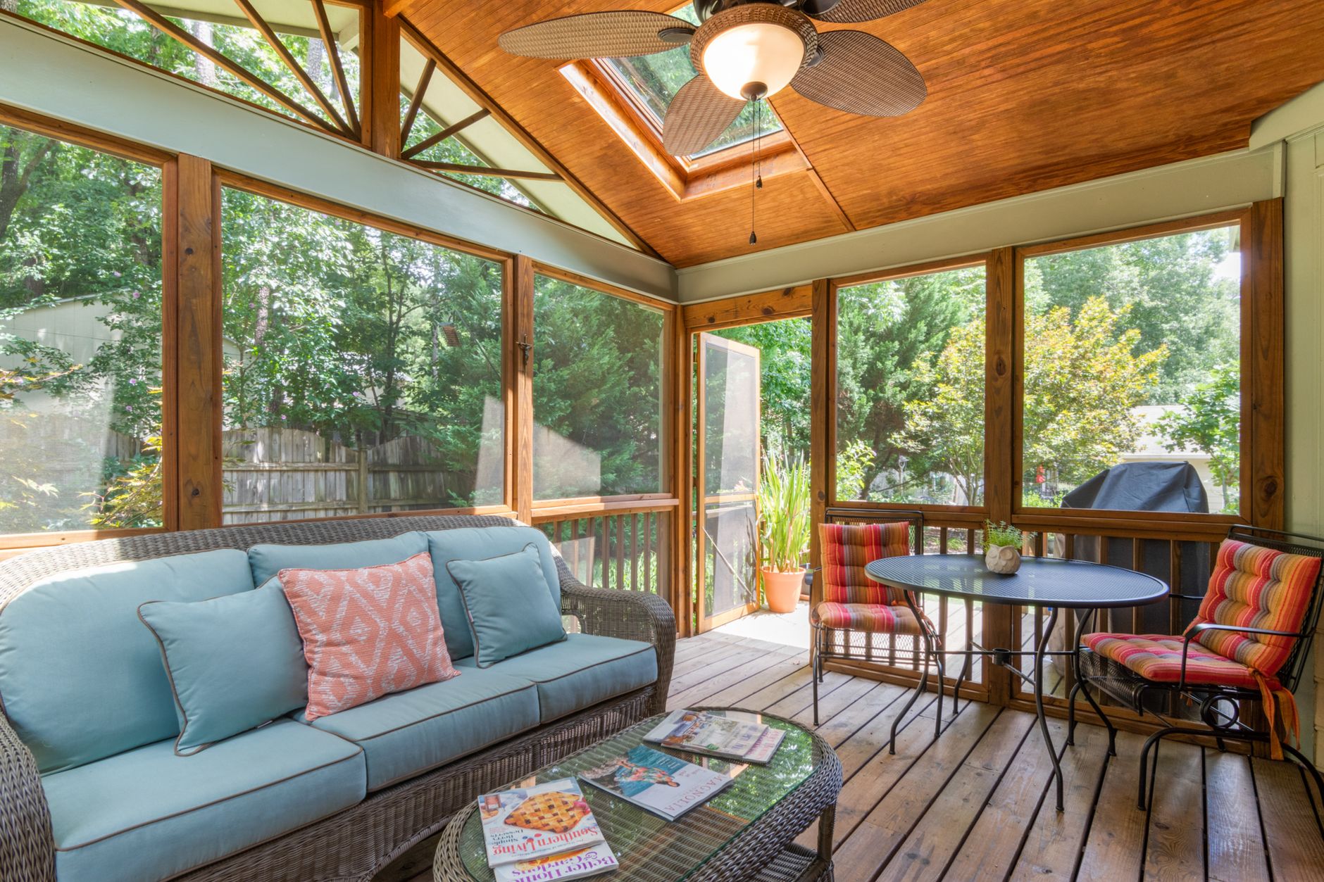 Side by side comparison of a glass sunroom and a screened porch addition on a New Orleans home