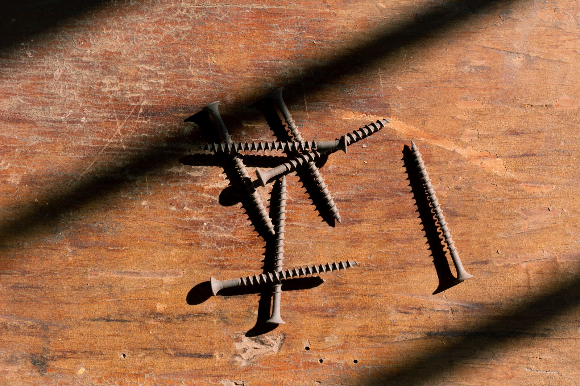 Rusted screws and corroded fasteners on an aging wood deck