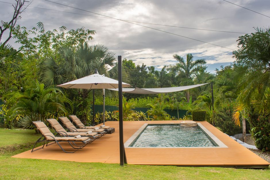 Content image 2  - A shaded poolside deck area with lounge chairs