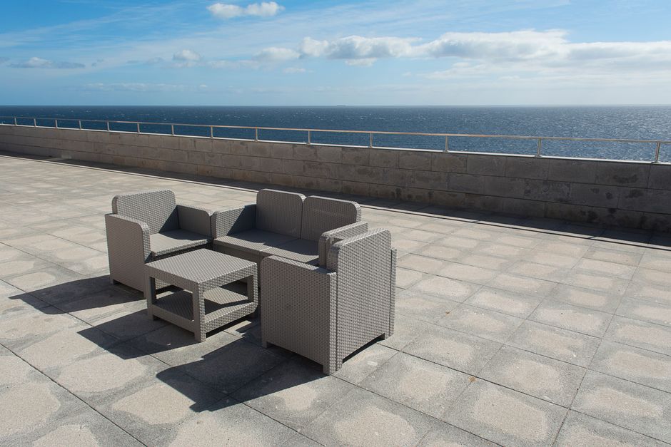 Content image 1  - A ground-level paver patio with outdoor furniture