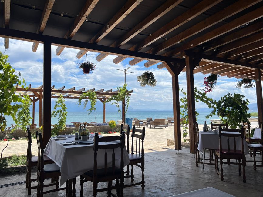 Content image 1 - A pergola with a retractable canopy shading a dining table