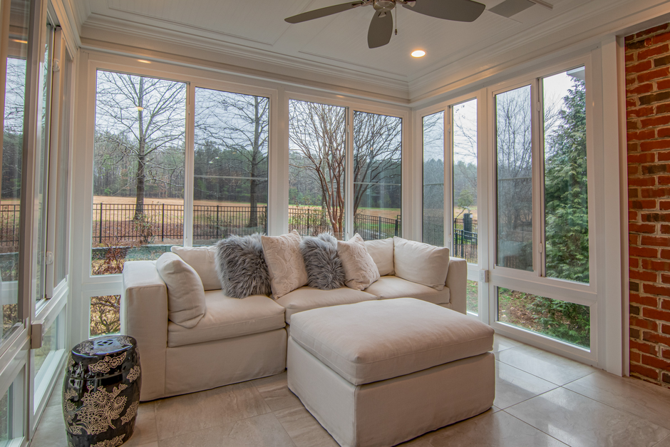 Content image 2 - A covered sunroom in winter with furniture arranged inside