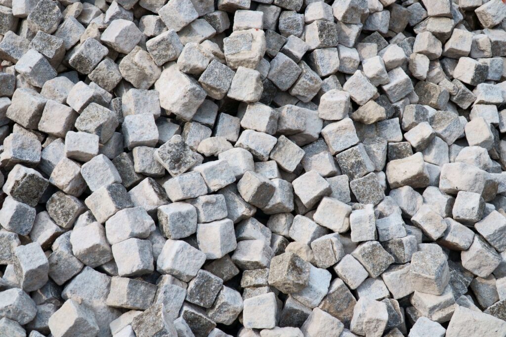 Pile of cut granite setts stacked ready for a patio installation