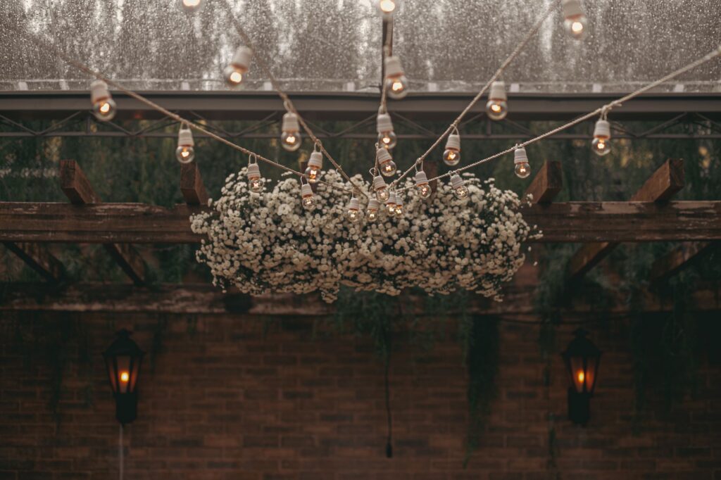 Outdoor pergola strung with warm string lights above a seating area