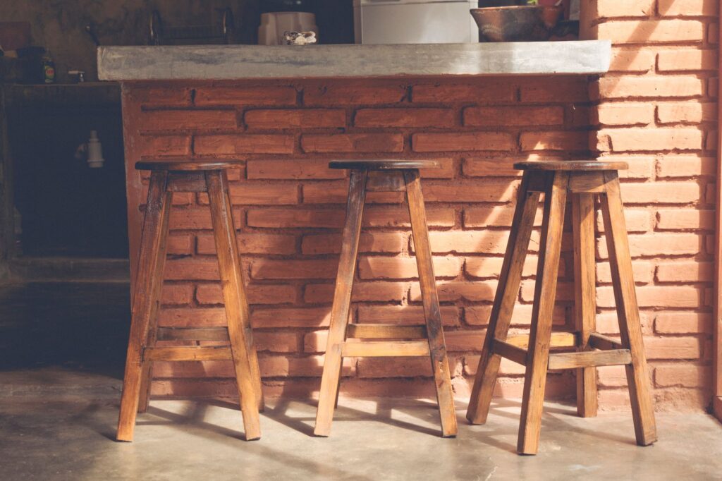 Brick outdoor bar counter with timber stools for casual seating