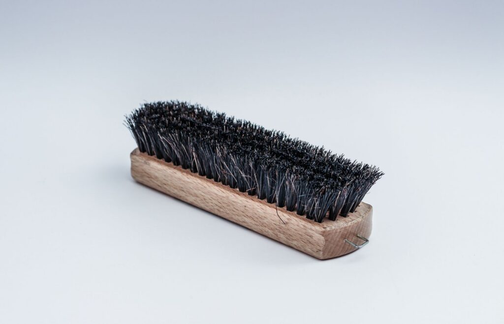 Stiff-bristled scrubbing brush of the type used to clean deck boards