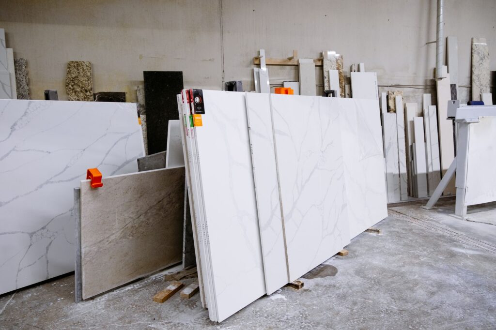 Porcelain and natural stone slabs standing on edge in a supplier yard, ready for countertop selection
